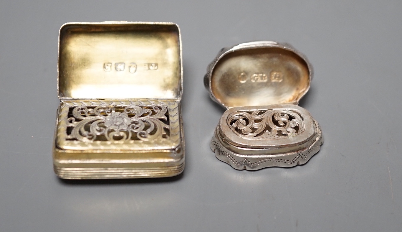 A George III silver gilt vinaigrette, TB, London, 1801, 30mm and a late shaped oval silver vinaigrette by George Unite, 27mm.